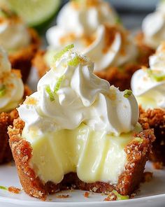 several cupcakes with whipped cream and lime on top