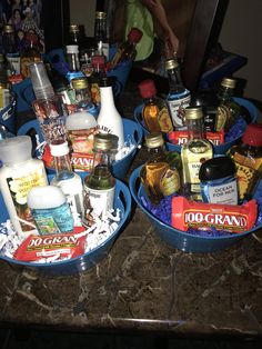 two blue bowls filled with condiments on top of a counter