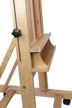 a wooden chair with wheels and shelves on it