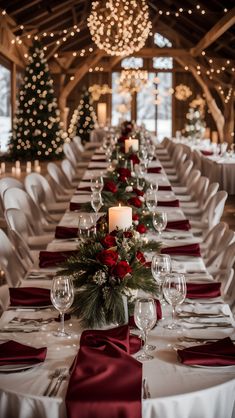 the tables are set with wine glasses and place settings for an elegant christmas dinner in a barn