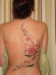 the back of a woman's body with flowers on it