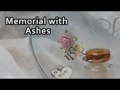 a glass plate topped with a piece of cake next to a pink flower and heart