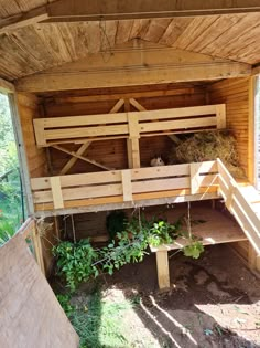 the inside of a wooden shelter with stairs leading up to it and plants growing on top