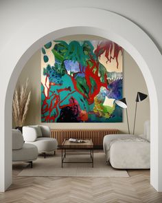 an archway leading into a living room with two couches and a painting on the wall