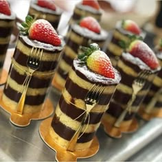 chocolate cake with strawberries on top and forks