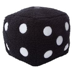 a black dice with white dots is shown on a white background and it's made out of knitted material