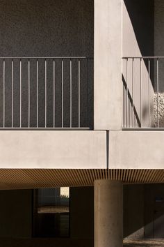 a man riding a skateboard down the side of a cement wall next to a parking garage