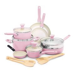 pink pots and pans with wooden utensils on a white background, all in one place