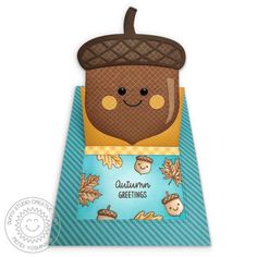 an oven mitt with the words autumn greetings written on it and a smiling acorn