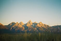 the mountains are covered in snow as the sun is setting on them and there is no image here to provide a caption for