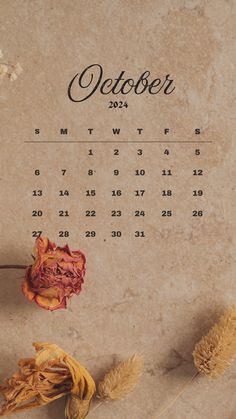 a desktop calendar with dried flowers on it