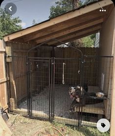 an outdoor dog kennel is shown with the door open to allow dogs to go outside