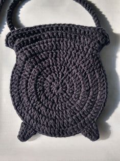 a crocheted purse sitting on top of a white surface