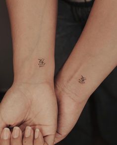 two people with matching tattoos on their arms