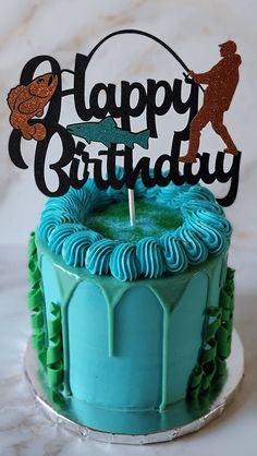 a birthday cake with blue icing and green frosting