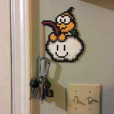 a key chain hanging from the side of a door with a cartoon character on it