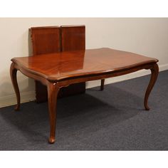 a wooden table sitting on top of a carpeted floor