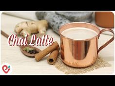 a copper mug filled with white liquid next to cinnamons