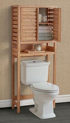 a wooden cabinet over a toilet in a bathroom