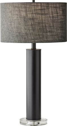 a table lamp with a grey shade on top and a black base, sitting on a white background