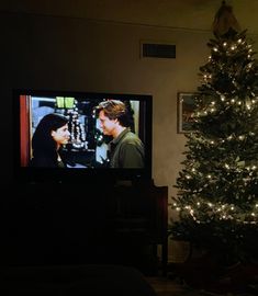 a christmas tree in front of a television with the twilight zone on it's screen