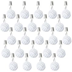 many white balls are tied together and hanging from the hooks on each side of them