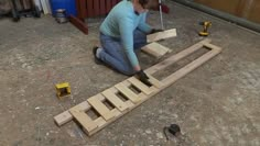 a woman is working on some wood planks