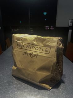 a brown paper bag sitting on top of a table