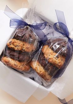 two chocolate chip cookies wrapped in cellophane and tied with a blue ribbon on top