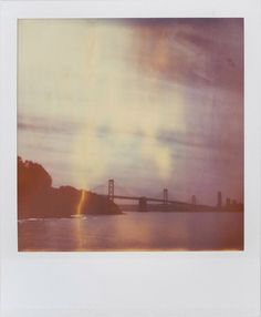 a polaroid photograph of the golden gate bridge in san francisco, california at sunset