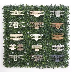 a green wall covered in lots of wooden cut outs