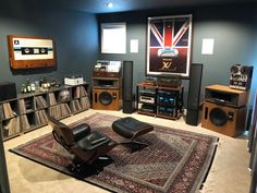 a room filled with lots of furniture and audio equipment on top of carpeted flooring