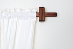 the curtain is hanging on the wall with a wooden rod attached to it's side