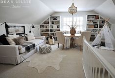 a living room filled with furniture and a baby crib in front of a window