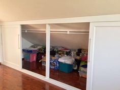 an empty room with closets and other items in the space on the far wall