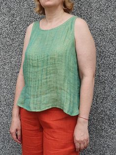 A green linen tank top crafted from high-quality breathable fabric. This top is perfect for warm days and mild evenings. The relaxed fit and sleeveless design offer comfort and freedom on movement while the subtle texture adds a touch of sophistication. Chest darts makes it more tailored. You can also like casual pants to match: https://debesyclothes.etsy.com/listing/1540334621 Composition & care instructions: 100% washed linen (flax), Lithuanian quality, medium weight 2 layers fabrics  Gentle m Linen Tank Top, Linen Tank, Top Crafts, Top For Women, Top Sleeveless, Sleeveless Blouse, Medium Weight, Womens Clothing Tops, Breathable Fabric