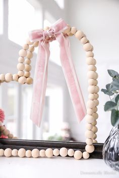 a wooden beaded frame sitting on top of a table