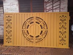 a yellow gate with an intricate design on it