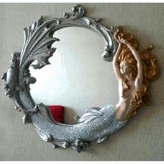 there is a mirror that has a mermaid on it