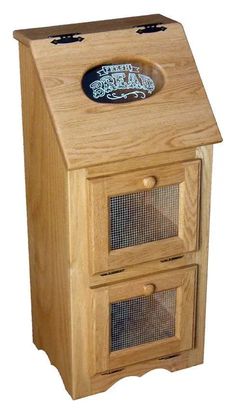 a wooden cabinet with two drawers and a birdcage on the bottom one drawer is open