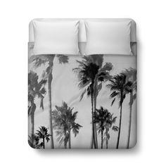 a black and white photo of palm trees on a duvet cover with matching pillow cases