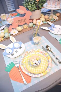 a table set for easter with plates, napkins and utensils on it