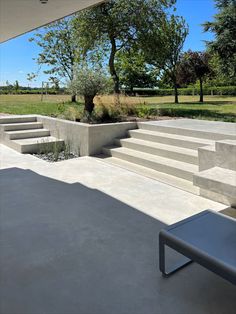 an outdoor area with concrete steps and trees