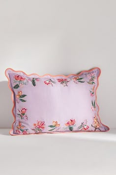 a pink pillow with flowers on it