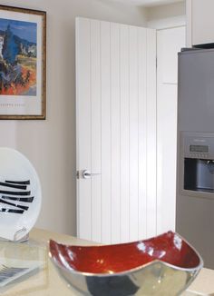 a bowl sitting on top of a counter next to a refrigerator