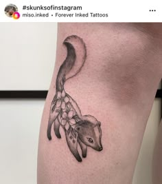 a tattoo on the leg of a woman with an animal in it's body