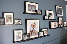 a wall with many pictures and frames on it