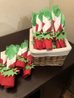 two baskets filled with green and red napkins on top of a table next to each other