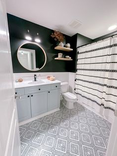 a bathroom with black and white tile on the floor