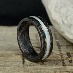 "Specifications: - 2.25mm Forged Carbon Fiber - .75mm Rose Gold (Or Metal of your choice) - 2mm Full Larimar - .75mm Rose Gold (Or Metal of your choice) - 2.25mm Forged Carbon Fiber The total width of this ring is 8mm, Comfort Fit What is Forged Carbon Fiber? This is an innovative material developed by Lamborghini that accentuates the beautiful marbled colors/patterns of Carbon Fiber while maintaining the high strength/durability of this material! We developed our own proprietary process to repl Forged Carbon Fiber, Opal Solitaire Ring, Antler Design, Triumph Daytona, Design Your Own Ring, Ring Styles, Ring Men, Aquamarine Stone, Custom Ring Designs